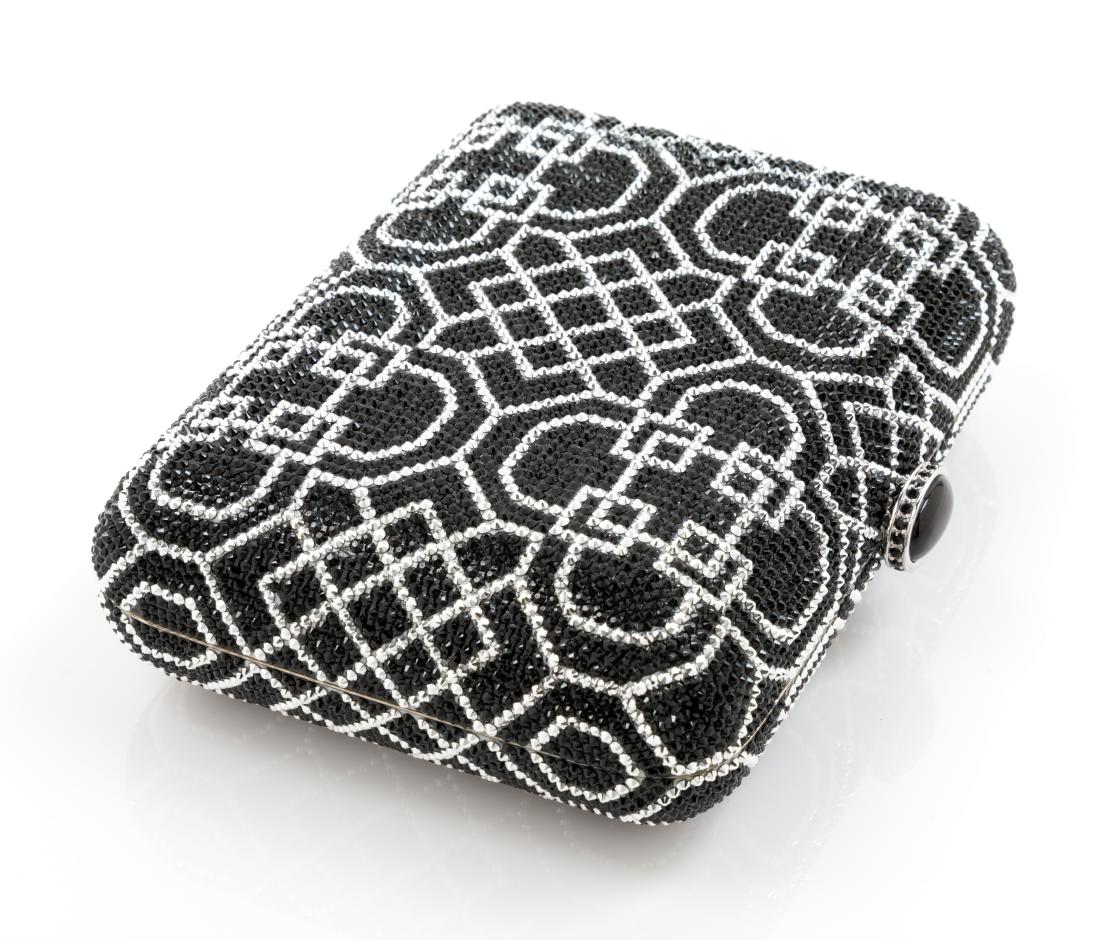Judith Leiber Black Geometric Motif Minaudiere: Judith Leiber Black Geometric Motif Minaudiere silvertone with silver lining and a chain shoulder strap. Stamp: Judith Leiber, New York. Established in 1963. Made in Italy. Estimate $200-300