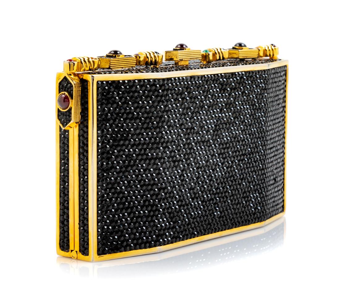 Judith Leiber Black Jeweled Bag: Judith Leiber Black Jeweled Bag goldtone with gold interior, multicolored stone and crystal top decorative bar with a push button closure. Together with a goldtone comb, mirror, and dustbag. Stamp: Ju