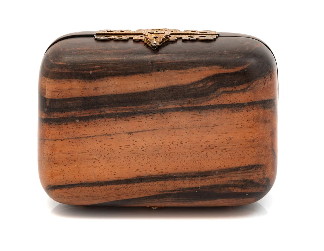 * Judith Leiber Carved Wood Clutch: * Judith Leiber Carved Wood Clutch A curved-edge rectangular wooden clutch with ornate metal frame and clasp. Gold leather lining with goldtone mirror included. Label: Judith Leiber Estimate $80-120 P