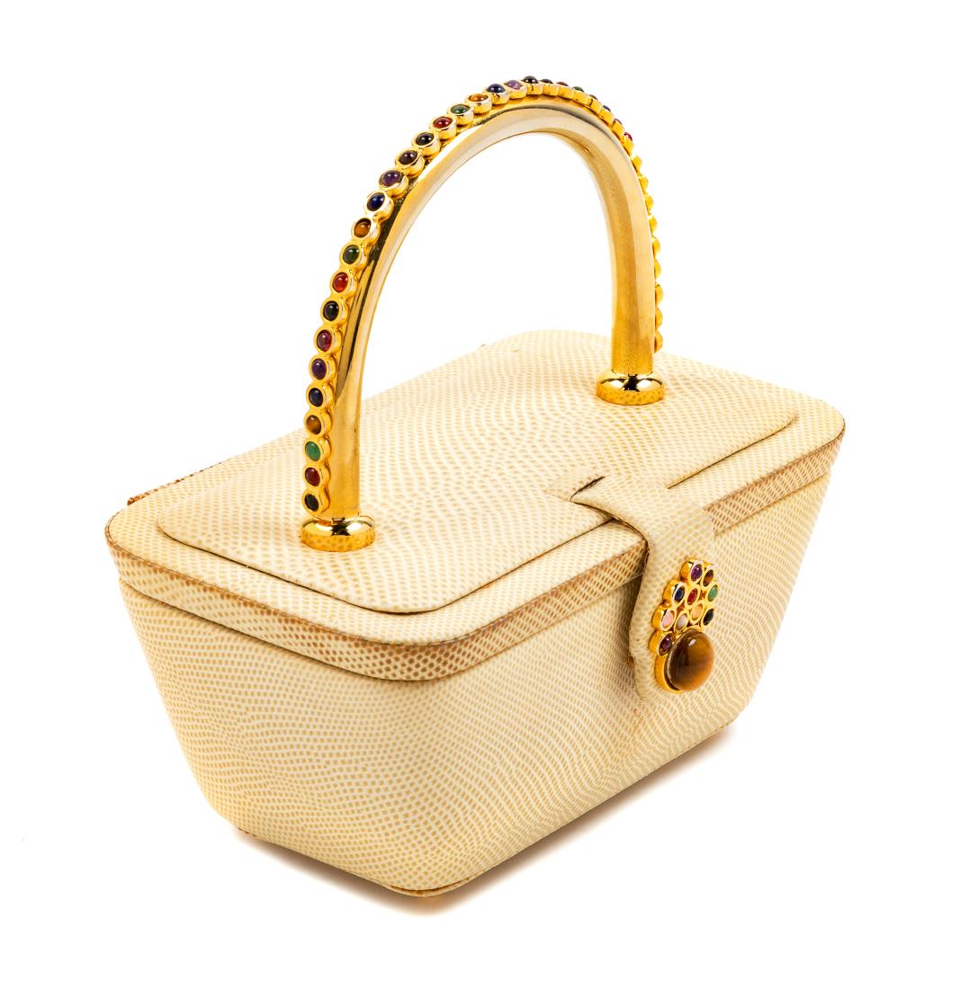 Judith Leiber Cream and Jeweled Box with Top Handle: Judith Leiber Cream and Jeweled Box with Top Handle goldtone hardware, lid top with a jeweled snap closure. Together with a mirror, coin purse, and dustbag. Stamp: Judith Leiber, New York. $150-200