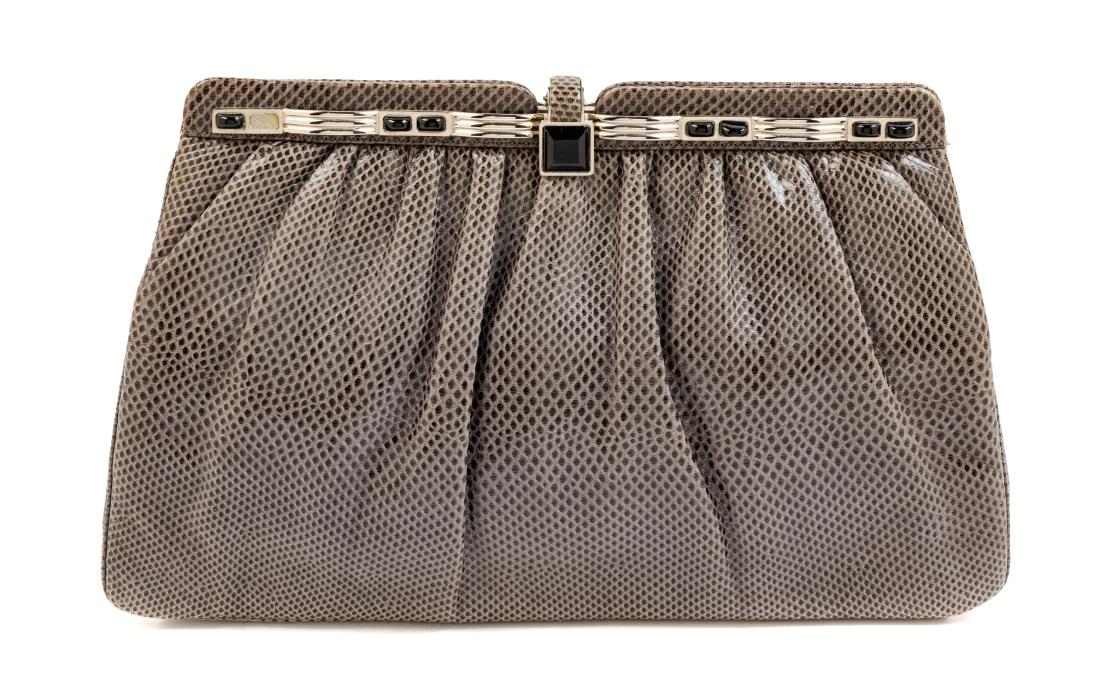 * Judith Leiber Grey Skin Bag: * Judith Leiber Grey Skin Bag silvertone hardware, black stones on frame and single square black stone on push/lift lock clasp, gray fabric lining with one zip pocket and one slip pocket, narrow skin
