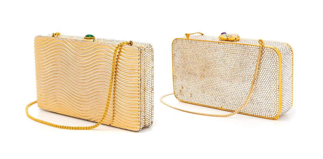 * Two Judith Leiber Jeweled Goldtone Clutches: * Two Judith Leiber Jeweled Goldtone Clutches The first: rectangular goldtone clutch with clear jewels and purple and pink glass on clasp, gold chain. Many missing and discolored jewels. Mirror includ