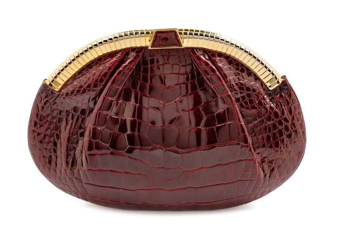 * Judith Leiber Maroon Crocodile Bag: * Judith Leiber Maroon Crocodile Bag goldtone hardware, interior maroon leather lining with a zip pocket and slip pocket, lift/push down locking clasp, herringbone chain shoulder strap, together with