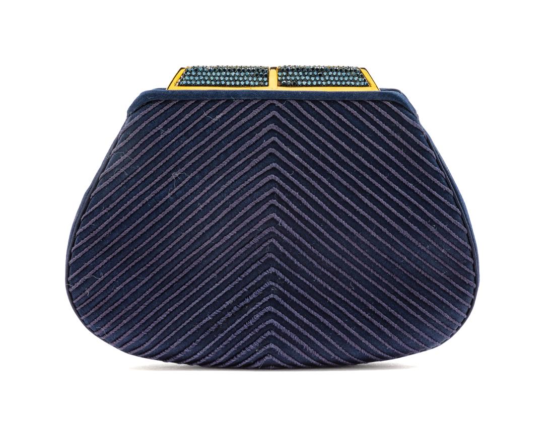 Judith Leiber Navy Blue Bag: Judith Leiber Navy Blue Bag goldtone hardware, front and back slip pockets, two interior slip pockets, top push bar closure with blue crystals. Stamp: Judith Leiber. Estimate $100-150