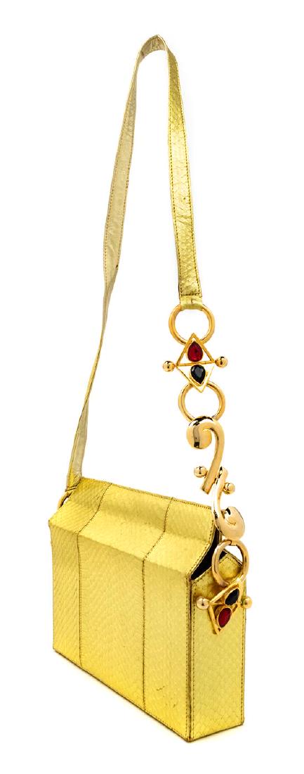 Three Gianni Versace Couture Decorative Handbags, 1990s: Three Gianni Versace Couture Decorative Handbags, 1990s Seafoam green clutch with large goldtone Medusa and Greco trim. Faux rocodile pink handbag with goldtone Medusa and Medusa medallions. Goldtone