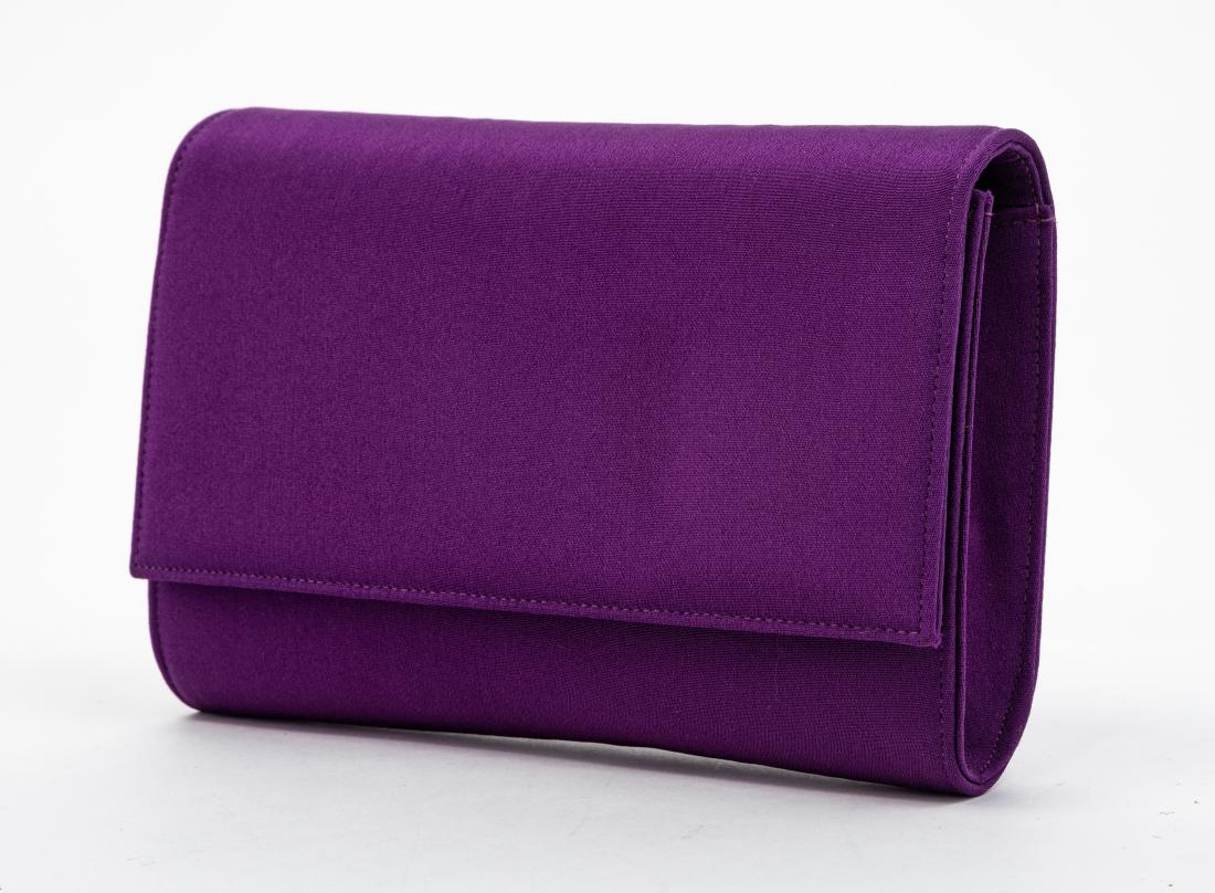 Two Gianni Versace Clutches, 1990s: Two Gianni Versace Clutches, 1990s One purple and one black. Label: Gianni Versace Estimate $80-120 The stated overall condition of the lot is based on the assumption that the wear is consistent with