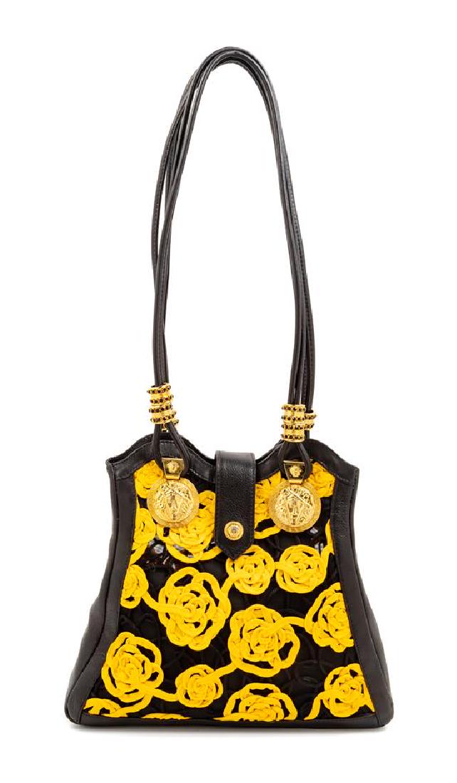 Gianni Versace Black Yellow Floral Handbag, 1990s: Gianni Versace Black Yellow Floral Handbag, 1990s black leather trim with black plastic mesh, embellished with black and yellow braid trim, goldtone hardware, narrow front flap with magnetic snap clos