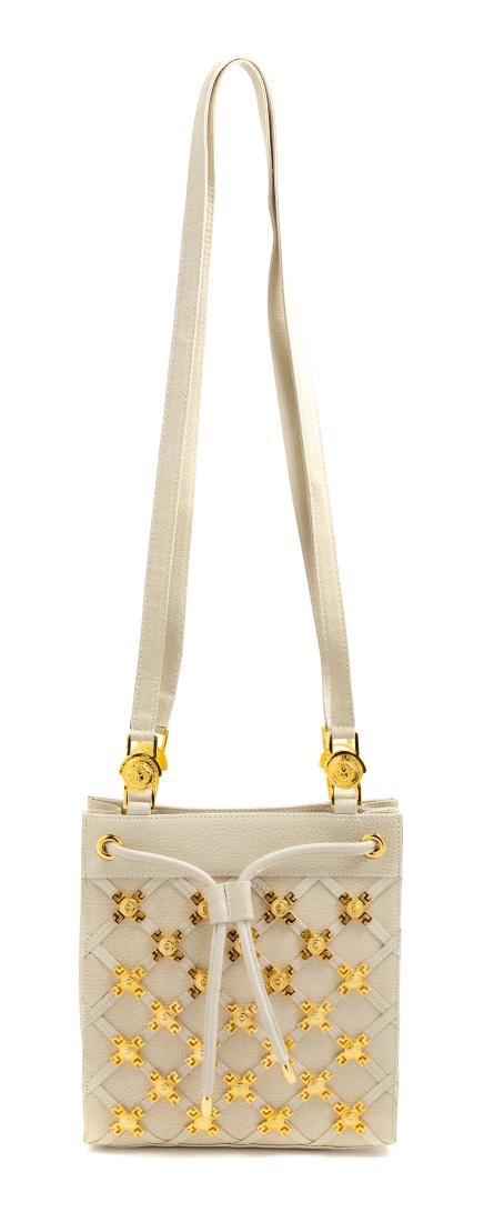 Gianni Versace Couture Beige Handbag with Goldtone: Gianni Versace Couture Beige Handbag with Goldtone Medallions, 1990s Estimate $150-250 The stated overall condition of the lot is based on the assumption that the wear is consistent with age and use.