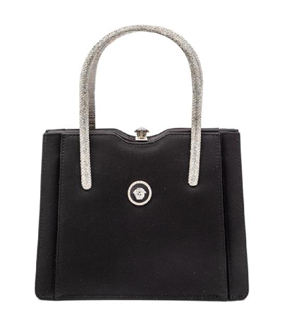Gianni Versace Couture Black Handbag with Medallion: Gianni Versace Couture Black Handbag with Medallion Medusa and Silvertone Handles, 1990s Measurements; L 8.25", W 3.5", H 6.5", strap drop 4" Estimate $100-200 The stated overall condition of the lot