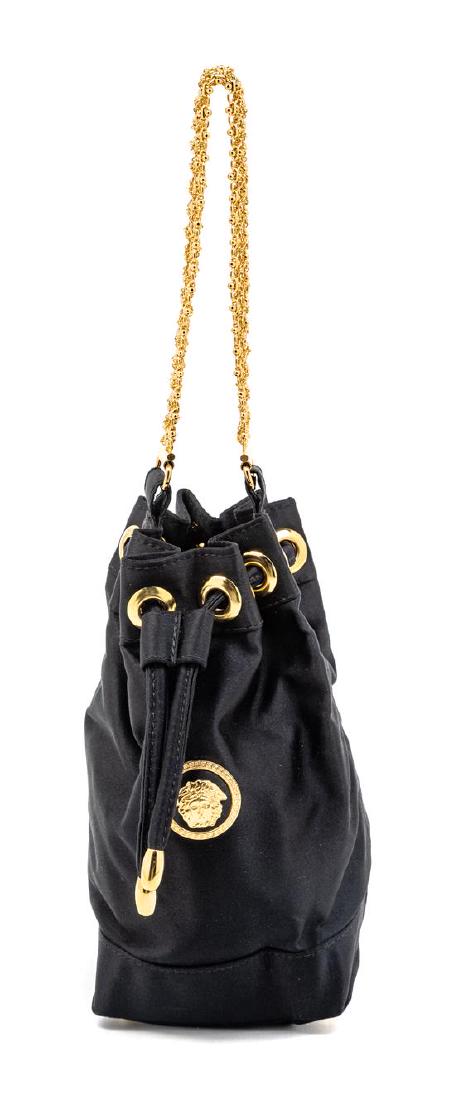 Gianni Versace Couture Black Satin Drawstring Handbag,: Gianni Versace Couture Black Satin Drawstring Handbag, 1990s With goldtone bracelet strap. Label: Gianni Versace Estimate $100-200