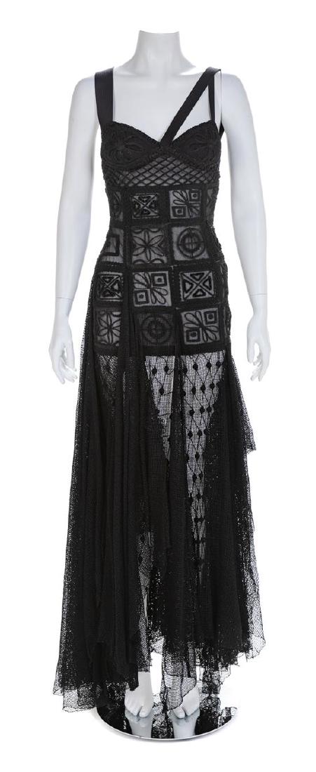 Atelier Versace Black Sheer Embroidered Gown, 1993-94: Atelier Versace Black Sheer Embroidered Gown, 1993-94 Fitted sheer silhouette extending to the high hip with emboidered floral motif in a variety of braids and top stitched shoulder straps. Hanging fr