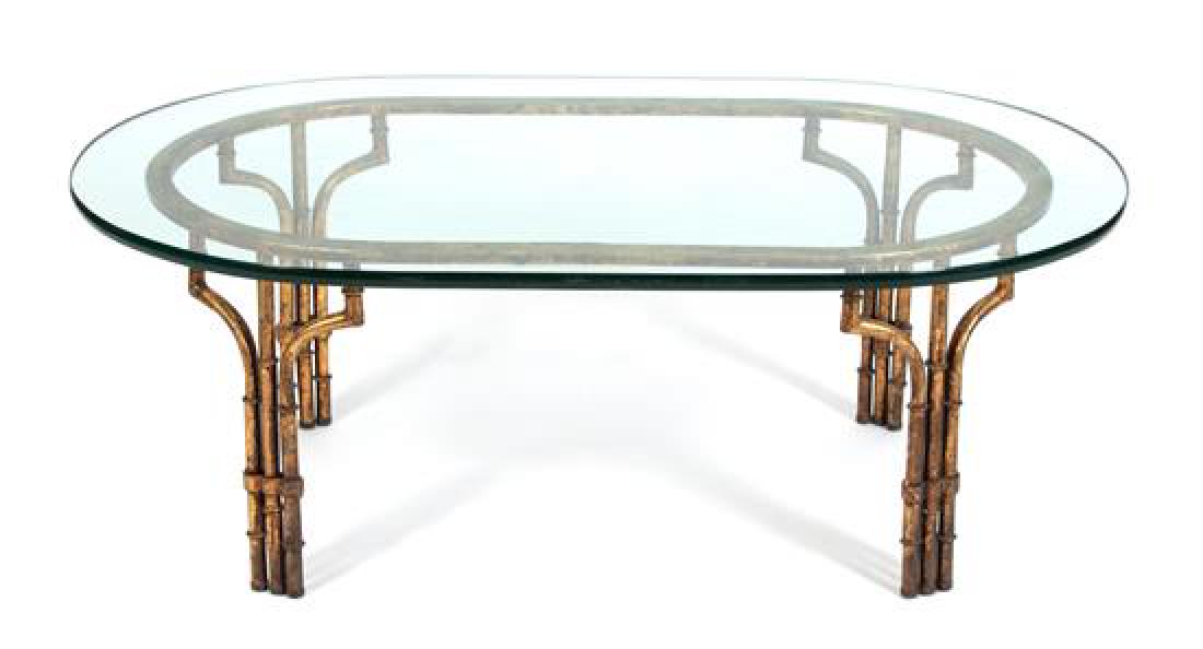 A Modern Gilt Metal Faux-Bamboo Glass Top Table: A Modern Gilt Metal Faux-Bamboo Glass Top Table 20th century Height 16 1/4 x width 44 x depth 28 inches. Estimate $150-250 Property from the Estate of Ian MacKay Kean, 2 Via Mizner, Palm Beach, FL