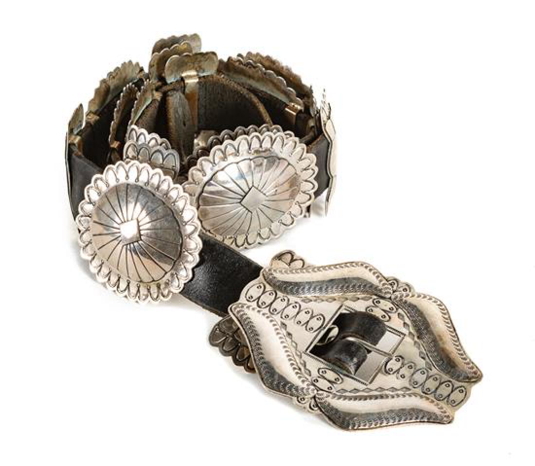 Southwestern Stamped Silver Concho Belt Length 37: Southwestern Stamped Silver Concho Belt having eight oval conchos alternating with nine butterflies and matching diamond form buckle Length 37 inches Estimate $500-700