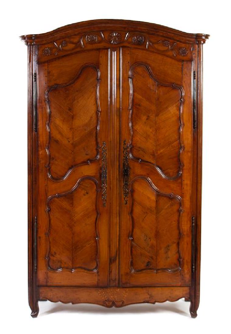 A Louis XV Style Inlaid and Carved Walnut Armoire: A Louis XV Style Inlaid and Carved Walnut Armoire OF PARTIAL EARLY 19TH CENTURY DATE The arched cornice above a pair of doors opening to a later linen-lined interior, the scalloped apron inlaid with f