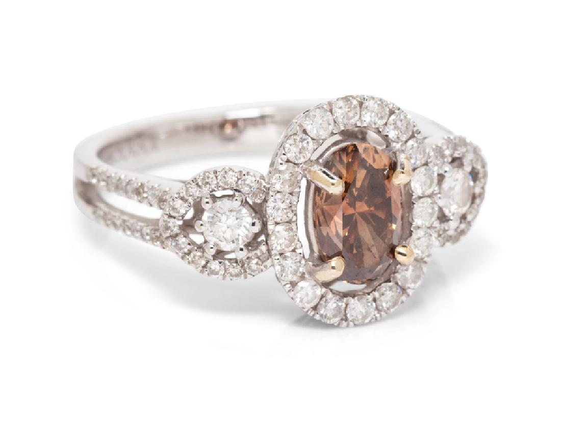 An 18 Karat White Gold, Colored Diamond and Diamond: containing one oval shape brilliant cut brown diamond (origin of color not tested) weighing approximately 1.00 carat and 96 round brilliant cut diamonds weighing approximately 0.70 carat total. Stamp:
