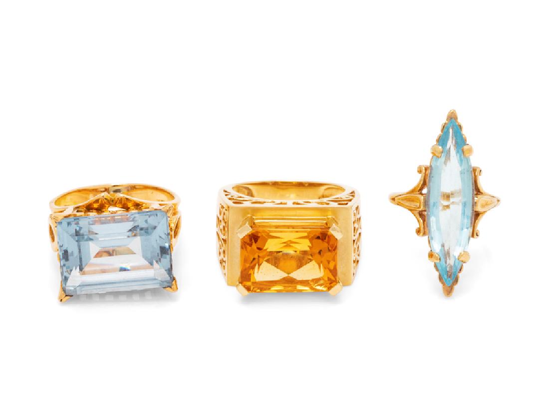 *A Collection of Yellow Gold and Gemstone Rings,: consisting of a 14 karat ring containing one octagonal mixed cut citrine measuring approximately 14.10 x 10.10 mm, an 18 karat ring containing one rectangular step cut synthetic blue spinel measuring 