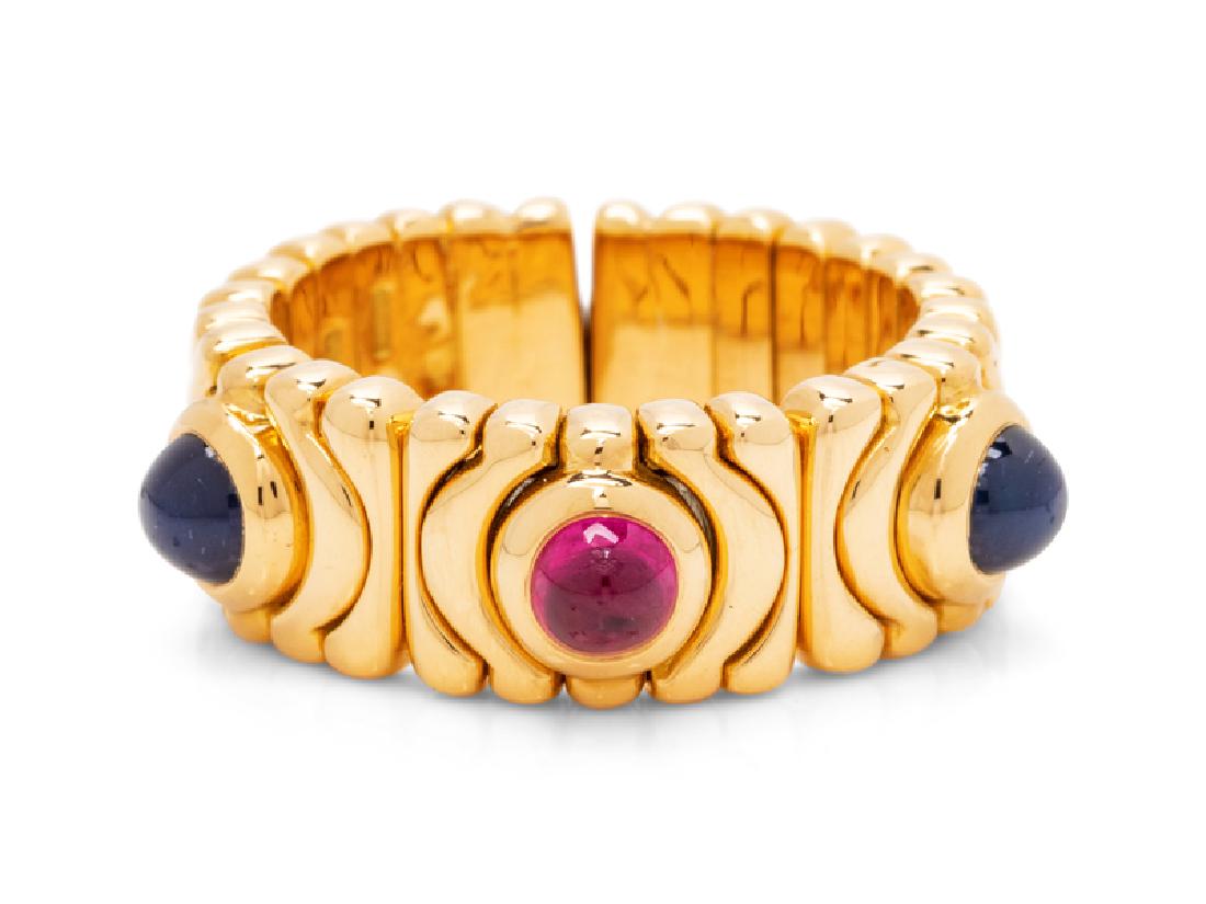 An 18 Karat Yellow Gold and Multigem Ring, Bvlgari,: containing three cabochon cut gemstones measuring approximately 3.90 mm in diameter. Stamp: BVLGARI 750 (Bulgari Italian hallmark). 8.95 dwts.