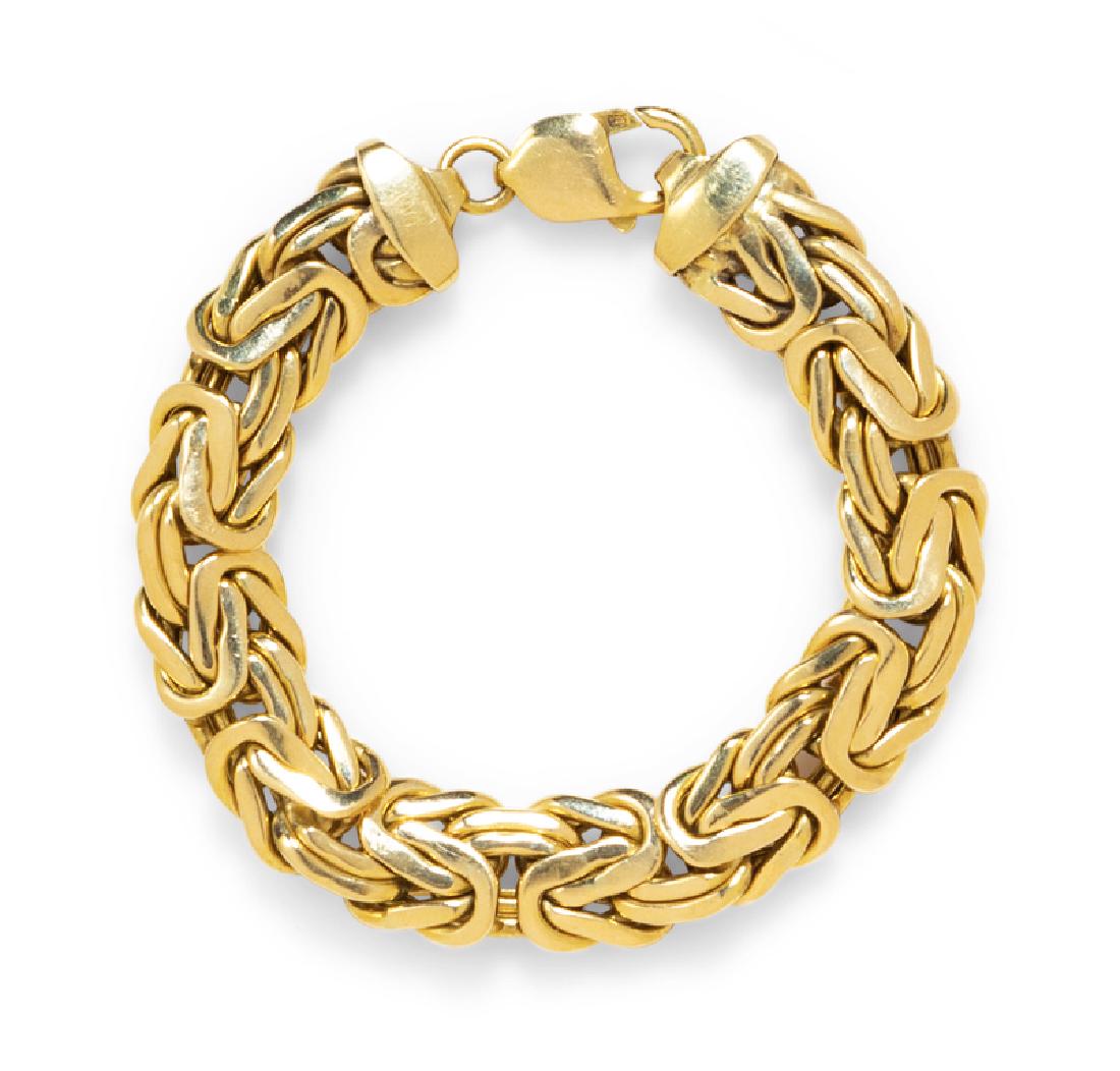 A 14 Karat Yellow Gold Bracelet,Ã‚Â : consisting of a flat Byzantine link chain measuring approximately 13.00 mm wide. Stamp: 14K. 23.25 dwts. Provenance: Property from the Estate of Jacqueline Macomber, Fox Point, Wisconsin