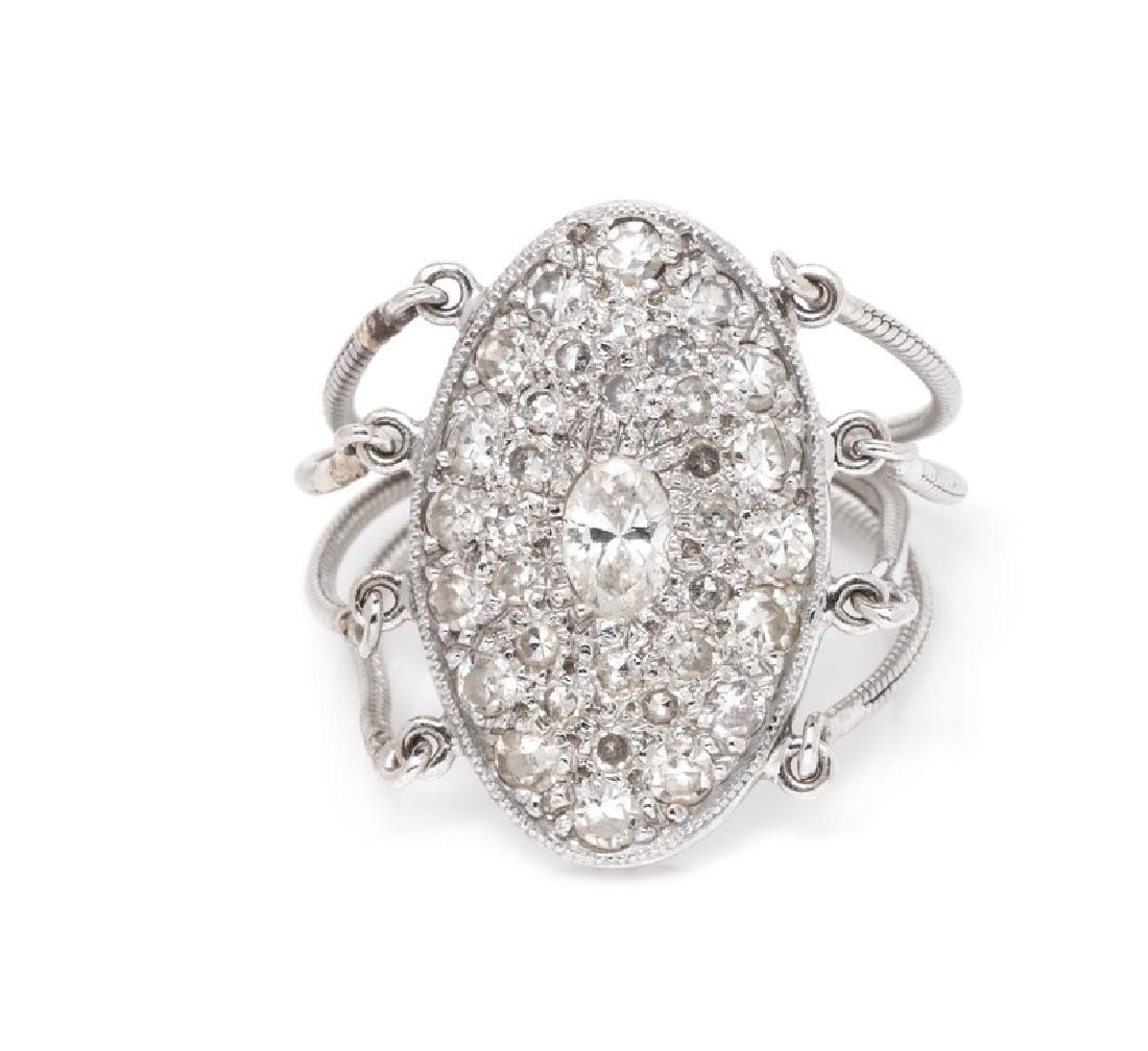 An 18 Karat Gold and Diamond Ring, Moritz Glik,: comprised of an oval shape plaque containing one oval shape diamond weighing approximately 0.12 carat and 35 single cut diamonds weighing approximately 0.30 carat total and quadruple snake chain shank