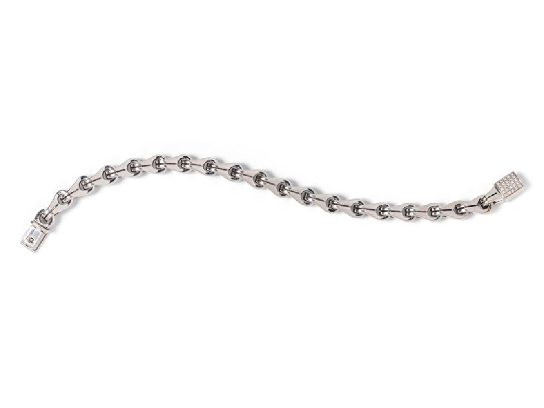 An 18 Karat White Gold and Diamond Bracelet, Di Modolo,: consisting of a fancy link chain measuring approximately 8.00 mm wide, the clasp containing 30 round brilliant cut diamonds weighing approximately 0.15 carat total. Stamp: Di MODOLO dm 750. 27.60 dwts
