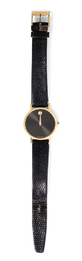 A 14 Karat Yellow Gold 'Museum' Wristwatch, Movado,: 30.00 mm case diameter, black dial, gold dot numeral at 12 o'clock, gold pitched dauphine hands, snap on case back, quartz movement, black lizard strap, gold tone tang buckle signed MOVADO. Case back