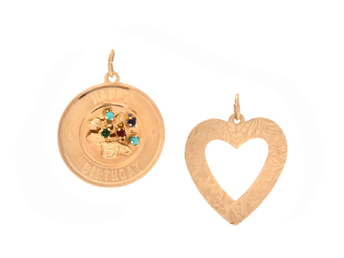 A Collection of 14 Karat Yellow Gold Charms,: consisting of a 'HAPPY BIRTHDAY' disc charm containing multicolored gemstones and an open heart pendant with floral motif engraved '12-25-68 The Boys' on reverse. Stamp: 08 14K. Bail stamp: 14K T C.