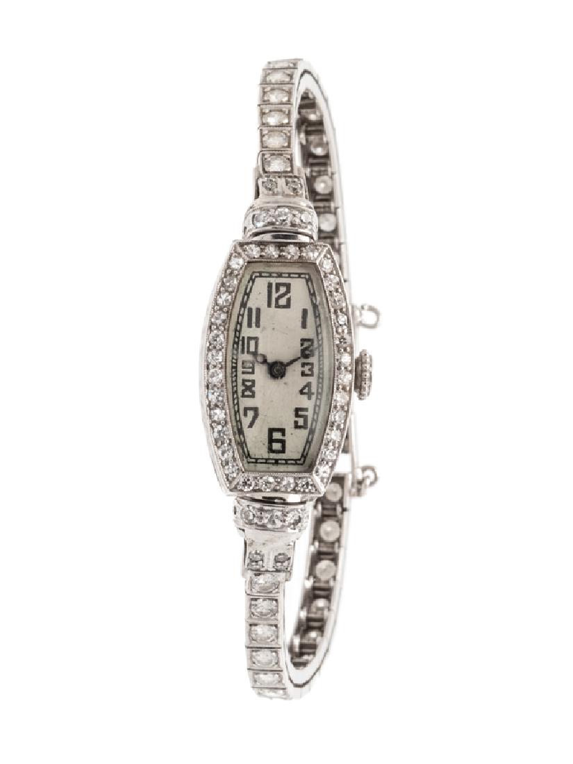 A White Gold, Platinum and Diamond Wristwatch,Â : the bezel and lugs containing 46 single cut diamonds weighing approximately 0.45 carat total, 13.00 x 22.00 mm case dimensions, matte silver dial, black Arabic numerals, blued steel hands, snap on cas