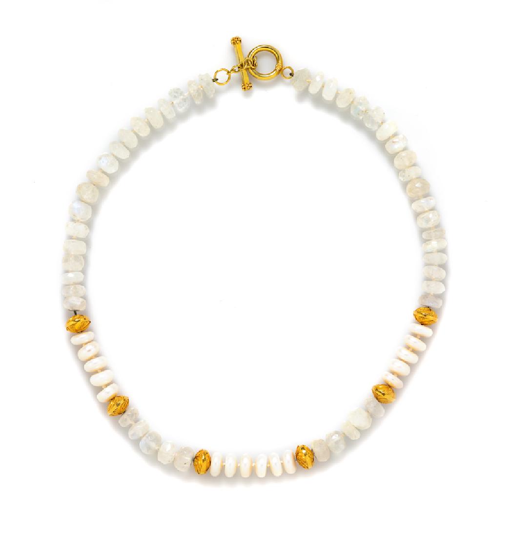 An 18 Karat Yellow Gold, Cultured Pearl and Moonstone: containing six high karat yellow gold beads with granular accents, 47 faceted moonstone beads and 10 button shape pearl beads strung knotted with an 18 karat yellow gold toggle clasp. Stamp: 18K. 38.0