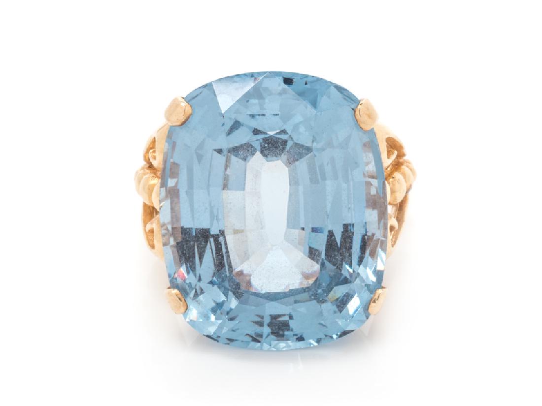 A 14 Karat Yellow Gold and Synthetic Blue Spinel: containing one cushion shape mixed cut synthetic blue spinel measuring approximately 24.60 x 19.88 x 12.28 mm. Stamp: 14K. 11.80 dwts.