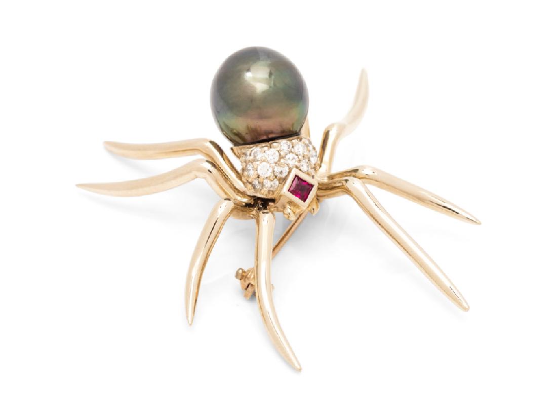 A 14 Karat White Gold, Cultured Tahitian Pearl, Ruby: containing one pearl measuring approximately 10.35 x 11.30 mm, one square mixed cut ruby and 20 round brilliant cut diamonds weighing approximately 0.35 carat total. Stamp: 14K G. 6.00 dwts. Provenanc