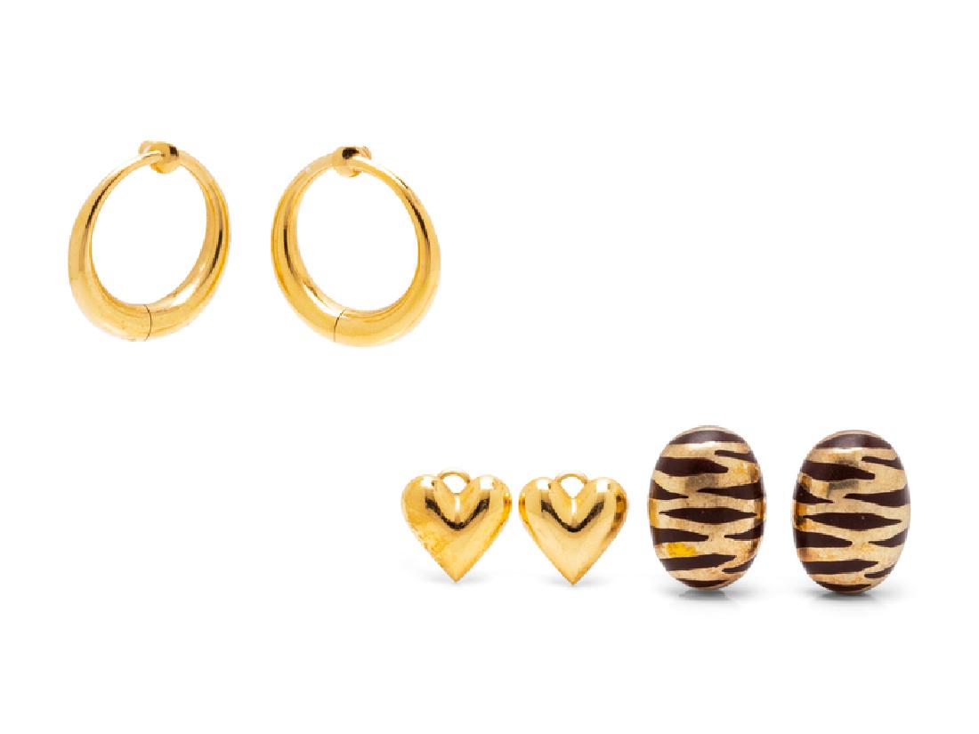 A Collection of Yellow Gold Earclips,: consisting of a pair of 14 karat gold hoop earclips, a pair of heart earclips, together with a pair of Italian sterling silver, gold and enamel zebra motif earclips. Stamp: 14 ct. Stamp: ITALY 925 (ma