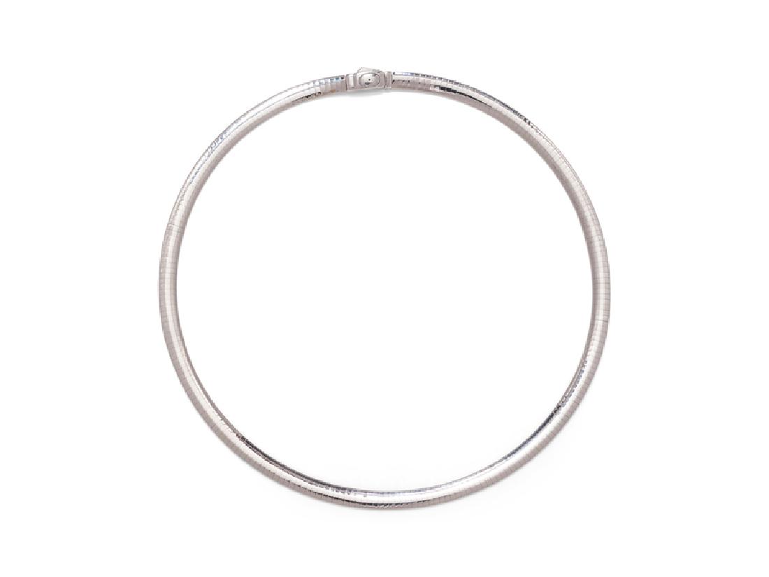 A 14 Karat Bicolor Gold Necklace, Italian,: consisting of an omega chain necklace with one side in white gold and the other in yellow gold, measuring approximately 6.10 mm wide. Stamp: 14Kt ITALY. 21.90 dwts. Provenance: Property from a Private