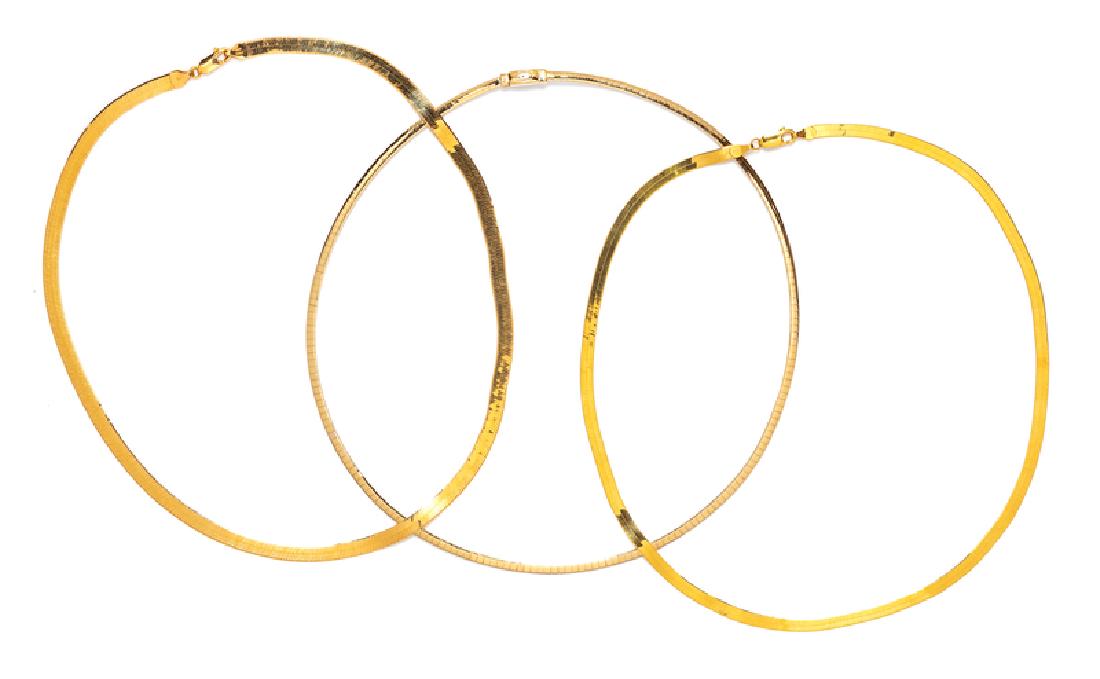 A Collection of 14 Karat Yellow Gold Necklaces,: consisting of a herringbone chain necklace measuring approximately 4.00 mm wide, a herringbone chain with engraved detail measuring approximately 5.00 mm wide, a bicolor gold omega chain necklace meas