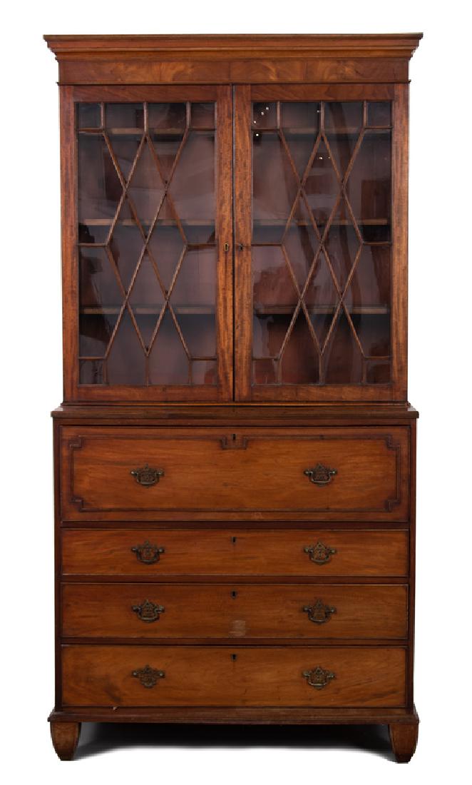 A George III Mahogany Secretary Bookcase: FIRST QUARTER 19TH CENTURY The thumb-molded cornice above two doors enclosing three adjustable shelves, the lower section with a secretary drawer over three graduated long drawers, raised on tapered f