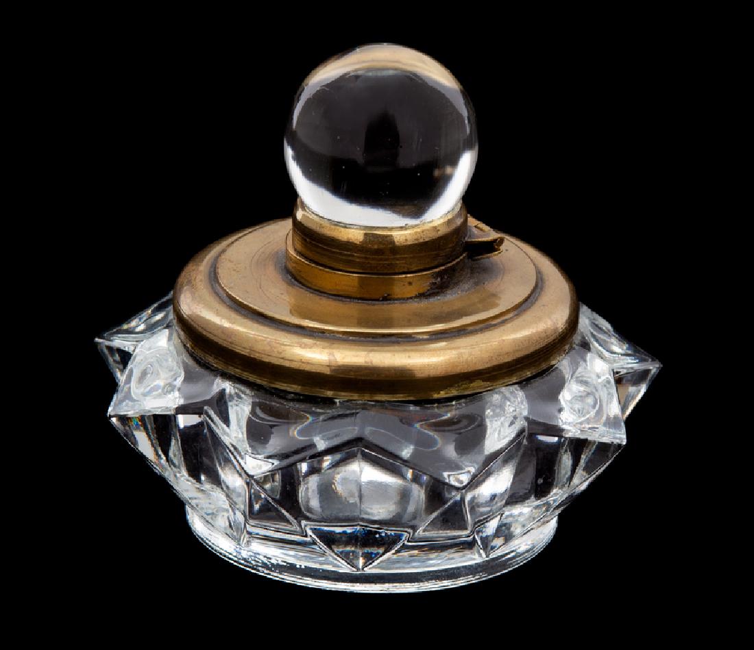 *A Brass Mounted Glass Inkwell : 20TH CENTURY having a glass ball finial, star form base. Height 3 1/4 inches. Provenance: Property from the Collection of M. Anthony Greene, Atlanta, Georgia