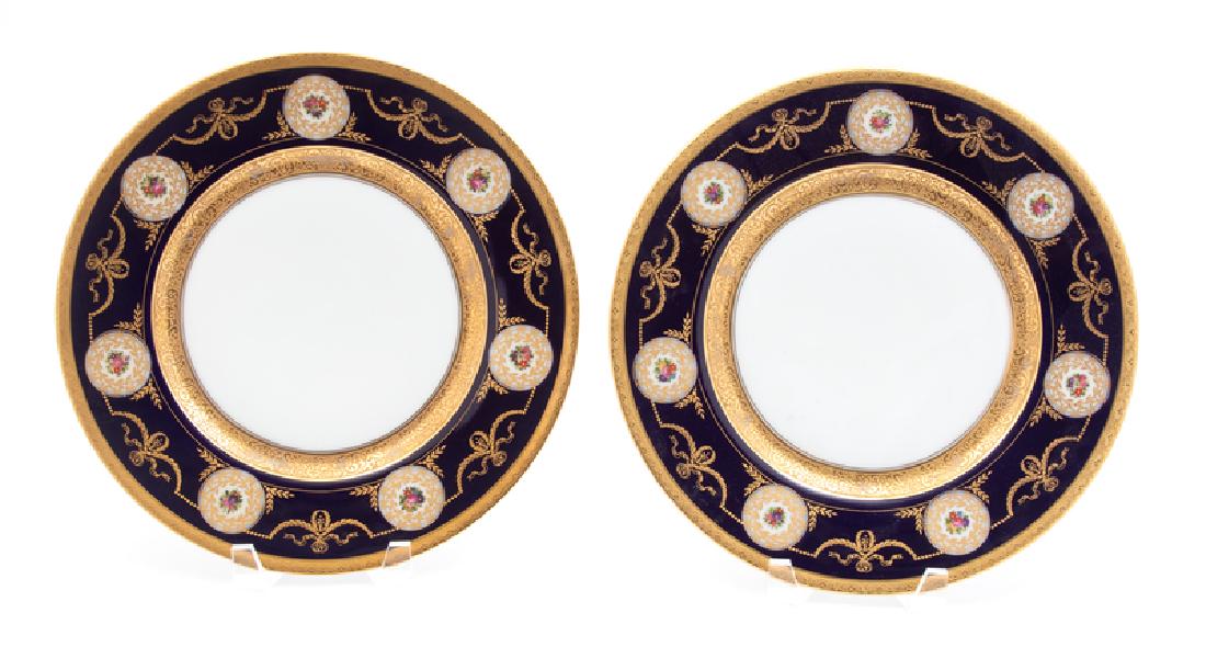 A Set of Twelve Hutchenreuther Polychrome Gilt: A Set of Twelve Hutchenreuther Polychrome Gilt Decorated Porcelain Plates having a wide cobalt blue border with floral roundels. 20TH CENTURY Diameter 10 1/2 inches.