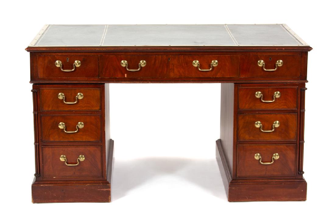 A George III Style Mahogany Pedestal Desk: A George III Style Mahogany Pedestal Desk LATE 19TH CENTURY having a green leather writing surface with brass surround. Height 30 x width 54 x depth 31 1/4 inches. LATE 19TH CENTURY