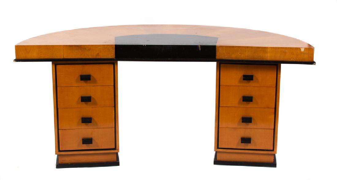 An Art Deco Maplewood Veneered Pedestal Desk: An Art Deco Maplewood Veneered Pedestal DeskKortrijkse Kunstwerkstede de Coene, Circa 1935Height 31 3/4 x width 71 1/2 x depth 39 inches.