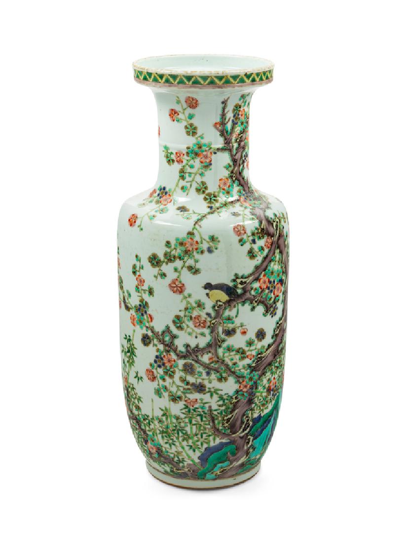 A Chinese Famille Verte Porcelain Rouleau Vase 20TH: A Chinese Famille Verte Porcelain Rouleau Vase 20TH CENTURY the cylindrical body painted with birds perched on the branches of a blossoming prunus tree issuing from rockworks, the underside bearing a 