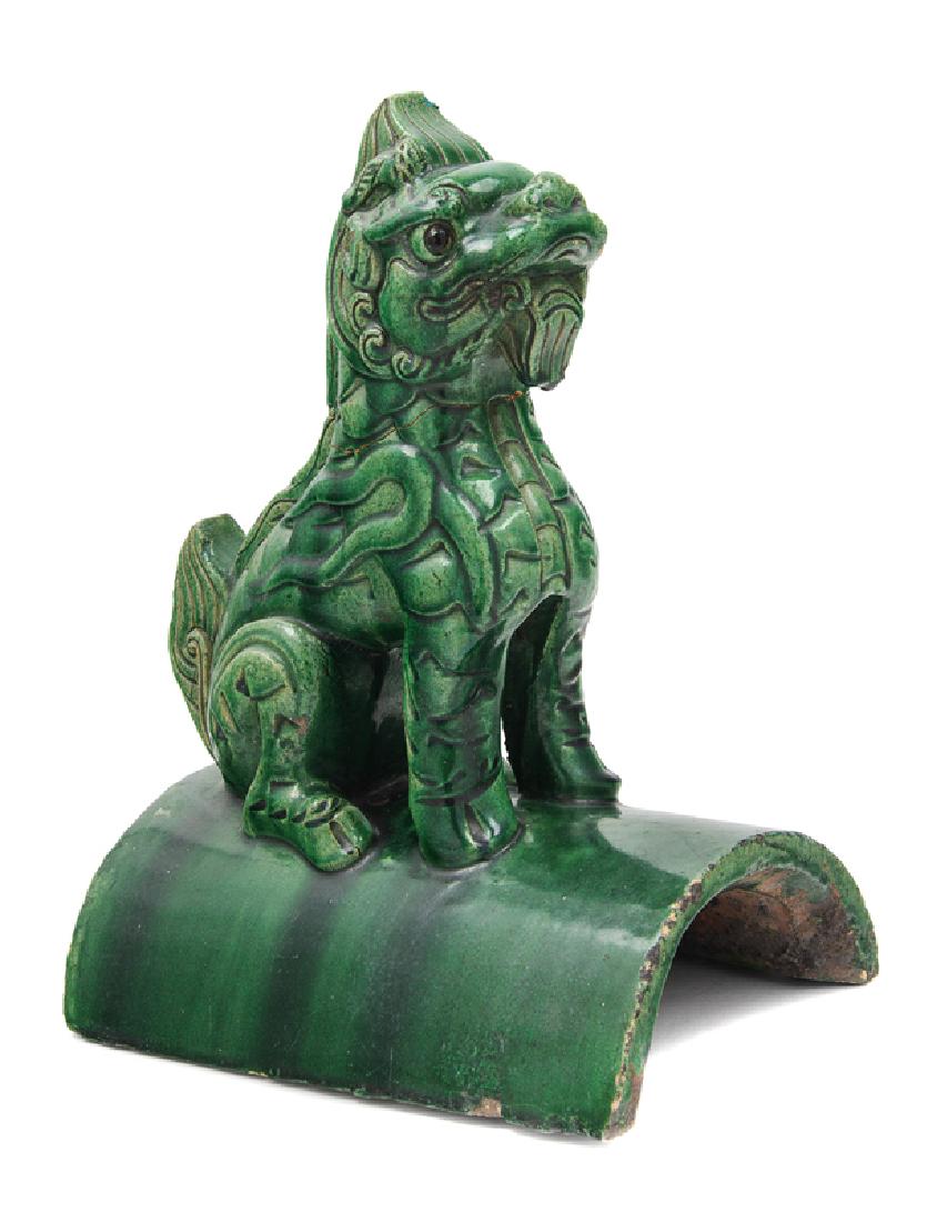 A Chinese Green Glazed Pottery Roof Tile 19TH CENTURY: A Chinese Green Glazed Pottery Roof Tile 19TH CENTURY modeled as a mythical beast seated on a domed tile, covered overall with a rich green glaze. 30 height centimeters,Height 12 inches. Property from