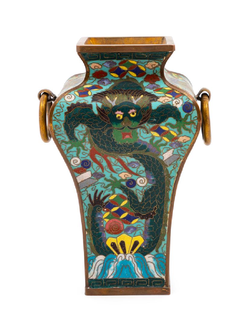 A Chinese Cloisonné Enamel Vase 20TH CENTURY of squared: A Chinese Cloisonné Enamel Vase 20TH CENTURY of squared meiping form with rounded shoulder rising to a short conical neck, flanked to the shoulder with two hanging handles. 19 height centimeters,7 1/