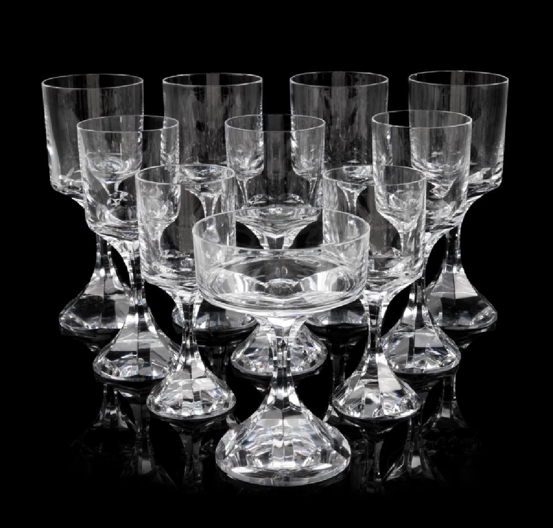 *A Baccarat Glass Stemware Service: *A Baccarat Glass Stemware Service Designed by Boris Tabacoff Narcisse pattern, comprising 9 champagne coupes, 9 water goblets (1 broken), 9 red wine glasses and 9 white wine glasses; 35 items total.