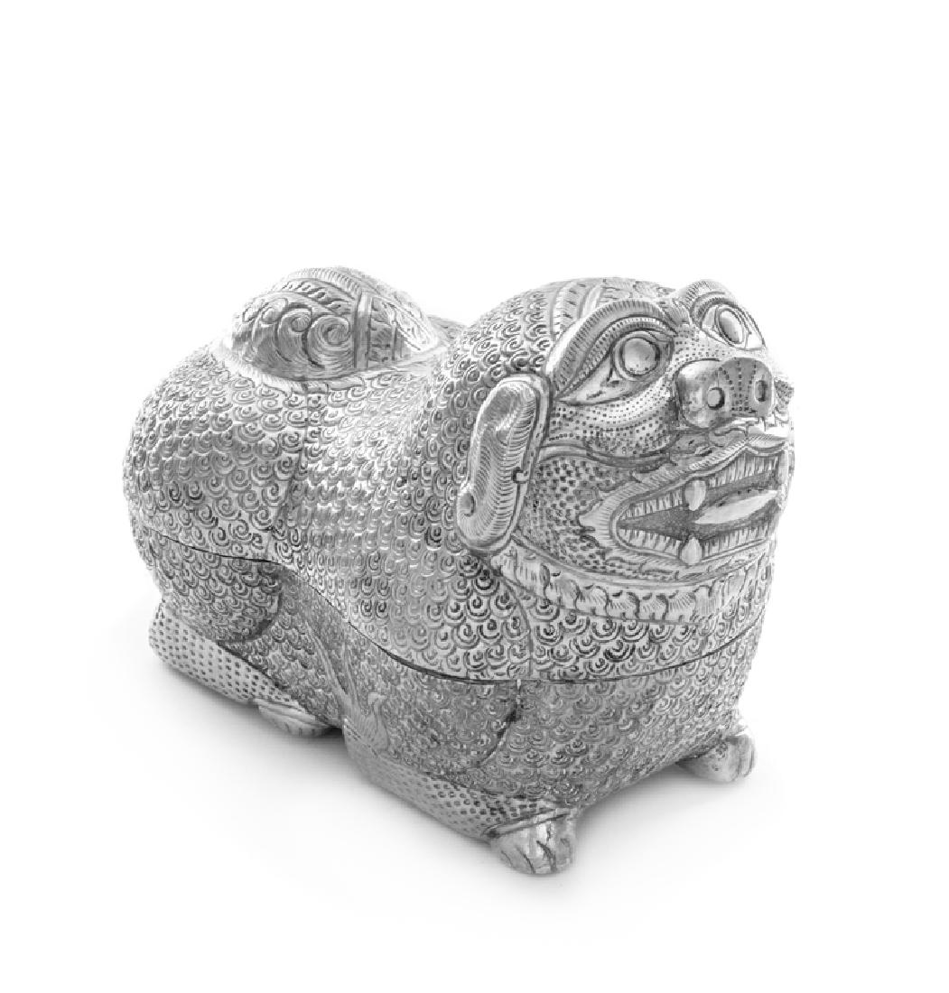 *A Southeast Asian Zoomorphic Table Casket: *A Southeast Asian Zoomorphic Table Casket Cambodia, 20th Century in the form of a temple guardian dog. 8 ozt 4 dwts Height 4 1/2 x width 6 1/2 inches. Property from the Violet Soffer Trust, Boca Rato