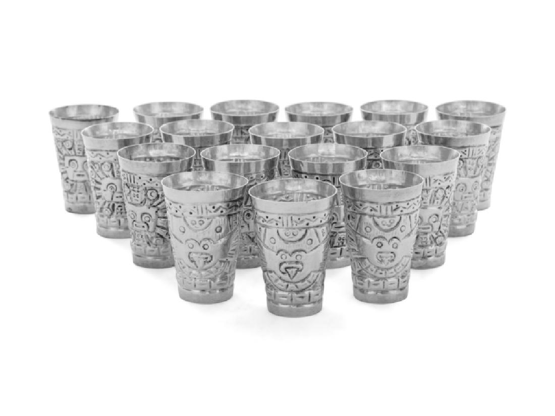 *A Set of Eighteen South American Shot Glasses: *A Set of Eighteen South American Shot Glasses 20th Century each worked to show Pre-Colombian motifs. etched '925' on underside 12 ozt 5 dwts Height 2 1/8 inches. Property from the Helen Simons Trust,