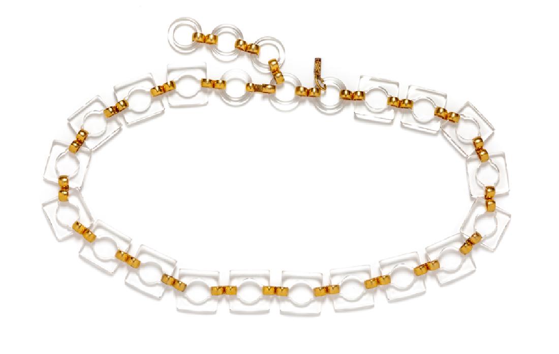 Yves Saint Laurent Lucite Necklace, 1970-80s: Yves Saint Laurent Lucite Necklace, 1970-80s Clear lucite squares with goldtone links with hook and lucite clasp. Stamped: YSL Approximate size: 31.5"-37" x 1.25" Condition: Overall good condition. We