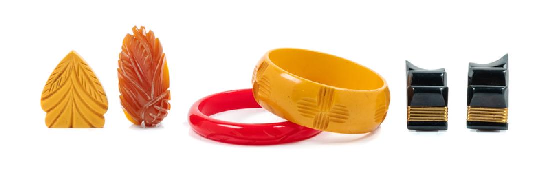 Collection of Bakelite, 1960-80s: Collection of Bakelite, 1960-80s The first: red bangle, 3" diameter The second: yellow bangle, 3" diameter The third: pair of black clips, 2" length x .75" width The fourth: one yellow clip, asymmetri