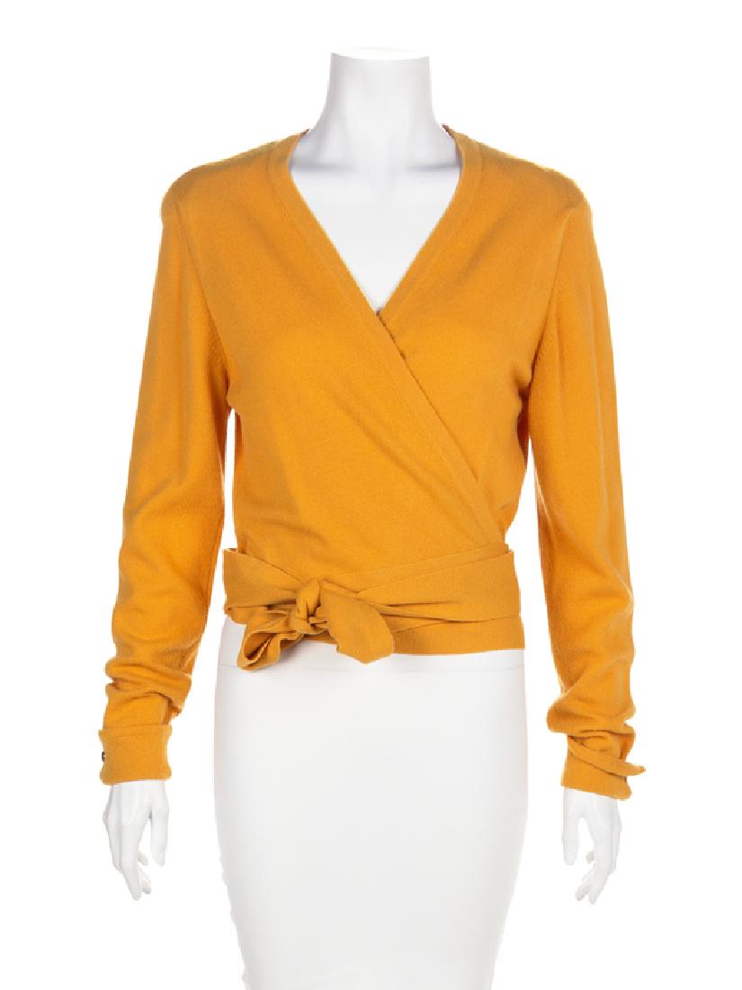 Chanel Cashmere Wrap Sweater, 1990-2000s: Chanel Cashmere Wrap Sweater, 1990-2000s Yellow cashmere knit sweater with long sleeves and a wrap front that secures with long waist ties. Sleeves have a French cuff with a single goldtone CC button.