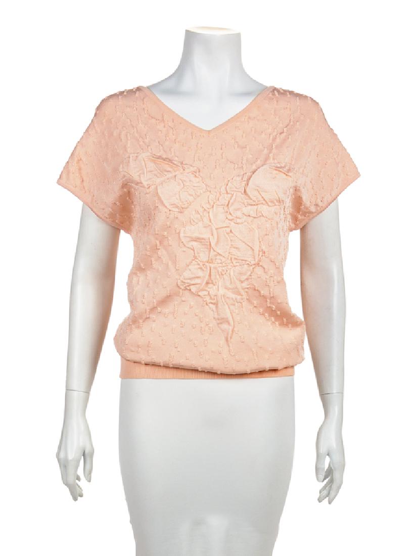 Chanel Sweater, 2010s: Chanel Sweater, 2010s Sleeveless v-neck pink sweater with a stylized and raised pattern. A small rectangular silverton piece with CC is stitched to the center back neck. Label: Chanel / Made in Italy 