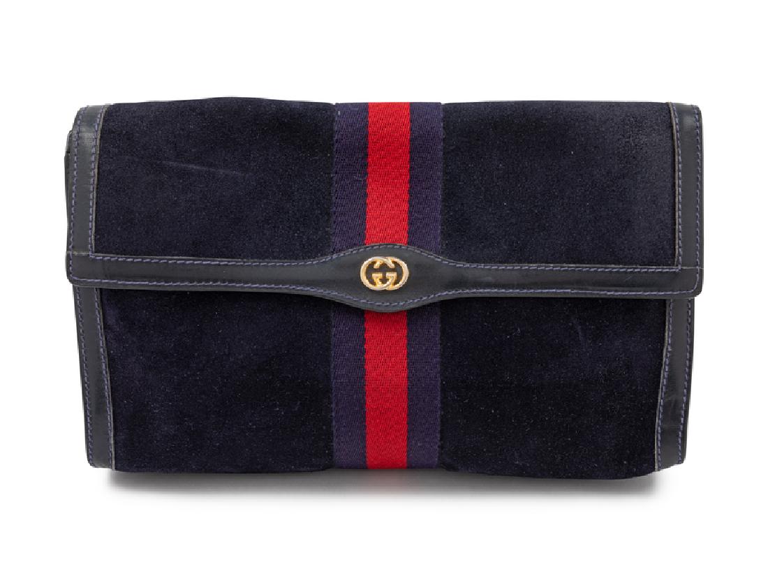 Gucci Vintage Clutch/Makeup Bag: Gucci Vintage Clutch/Makeup Bag Dark blue suede with blue and red web center trim, one compartment with plastic interior lining, front flap with GG logo and a pin snap button closure. Measurements: 11