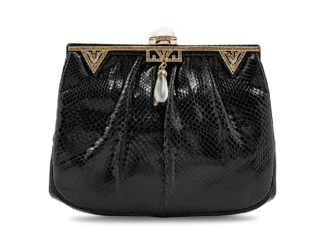 Judith Leiber Skin Clutch, 1980s: Judith Leiber Skin Clutch, 1980s Black skin bag gathered into an Art Deco-inspired rhinestone frame, silvertone hardware, black interior lining with two slip pockets, top push closure with a chain sho